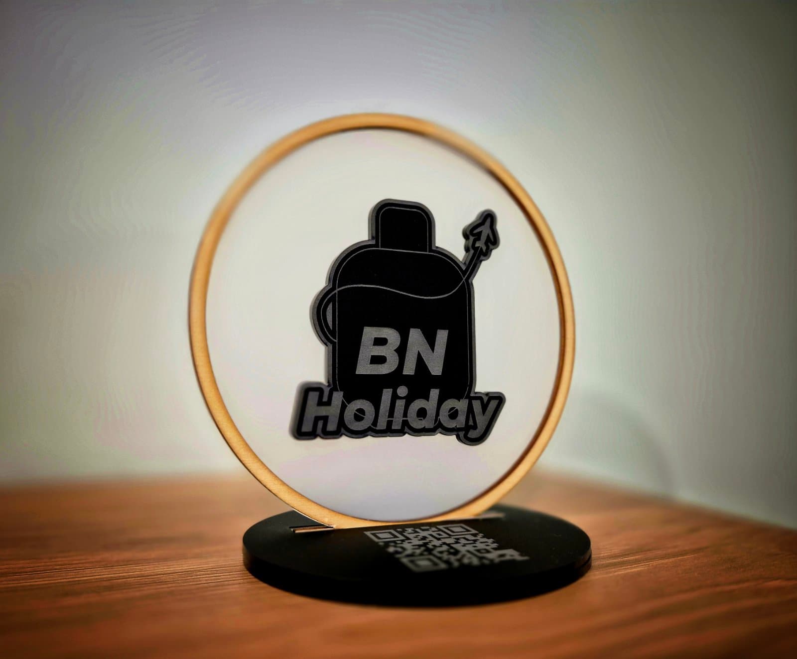 Decorative QR sign with 'BN Holiday' text on a wooden surface
