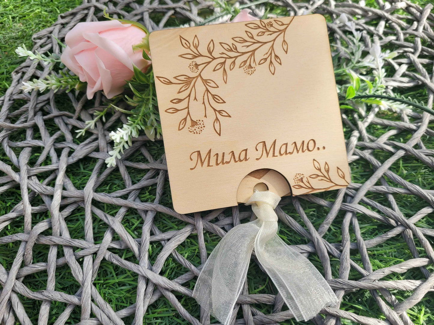 Wooden card with floral design and text on a decorative background