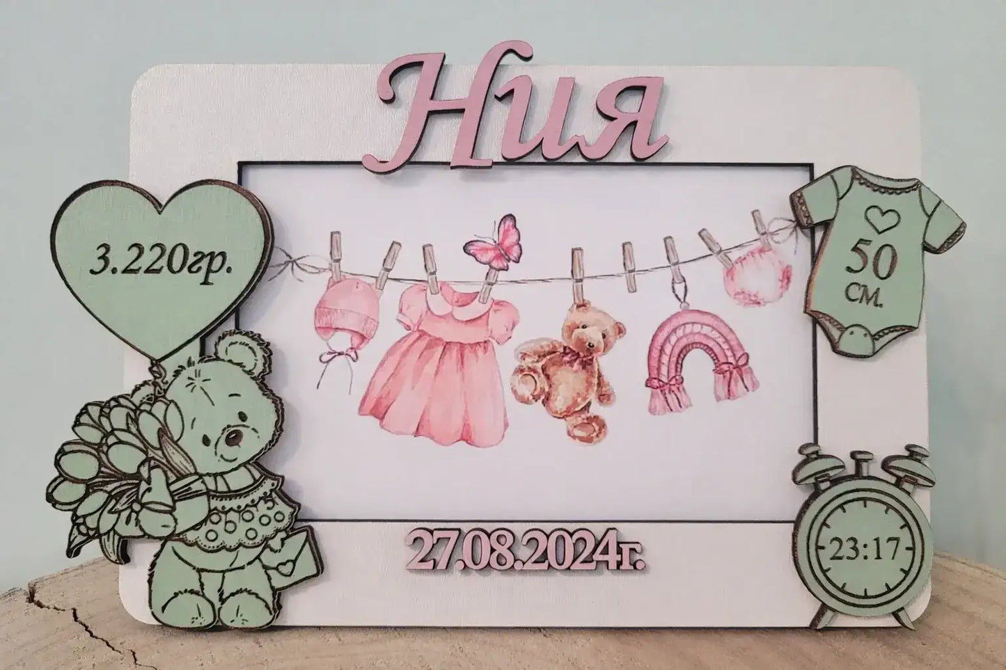 Decorative baby milestone board with illustrations and text on a light gray background